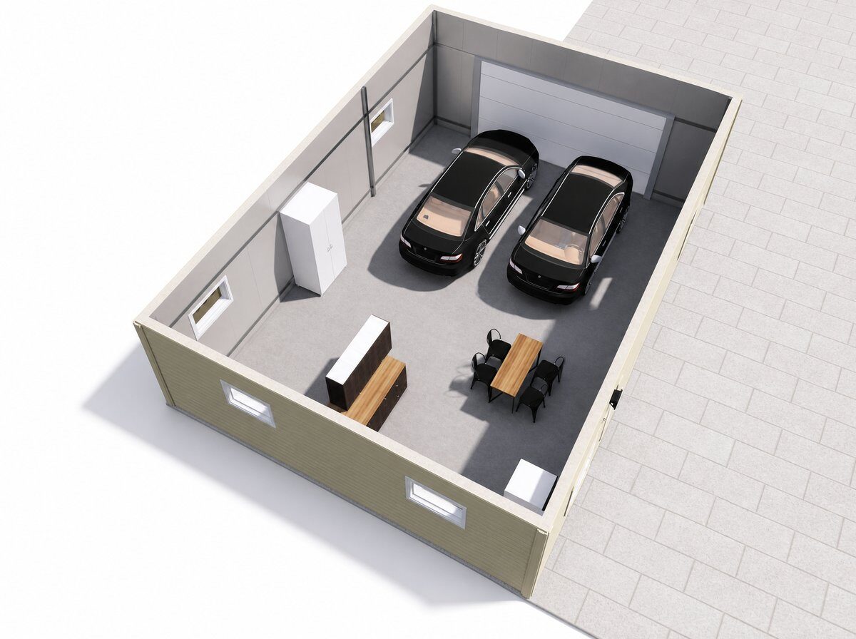 Cutaway view of an insulated steel garage interior — two cars, a workshop bench and seating inside a 100mm PIR building