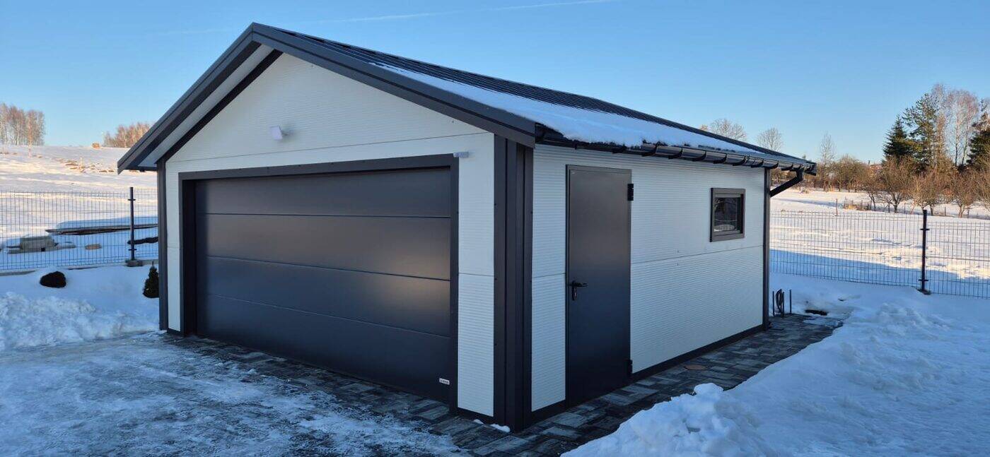 Cream insulated garage in winter snow, side elevation with a personnel door and window