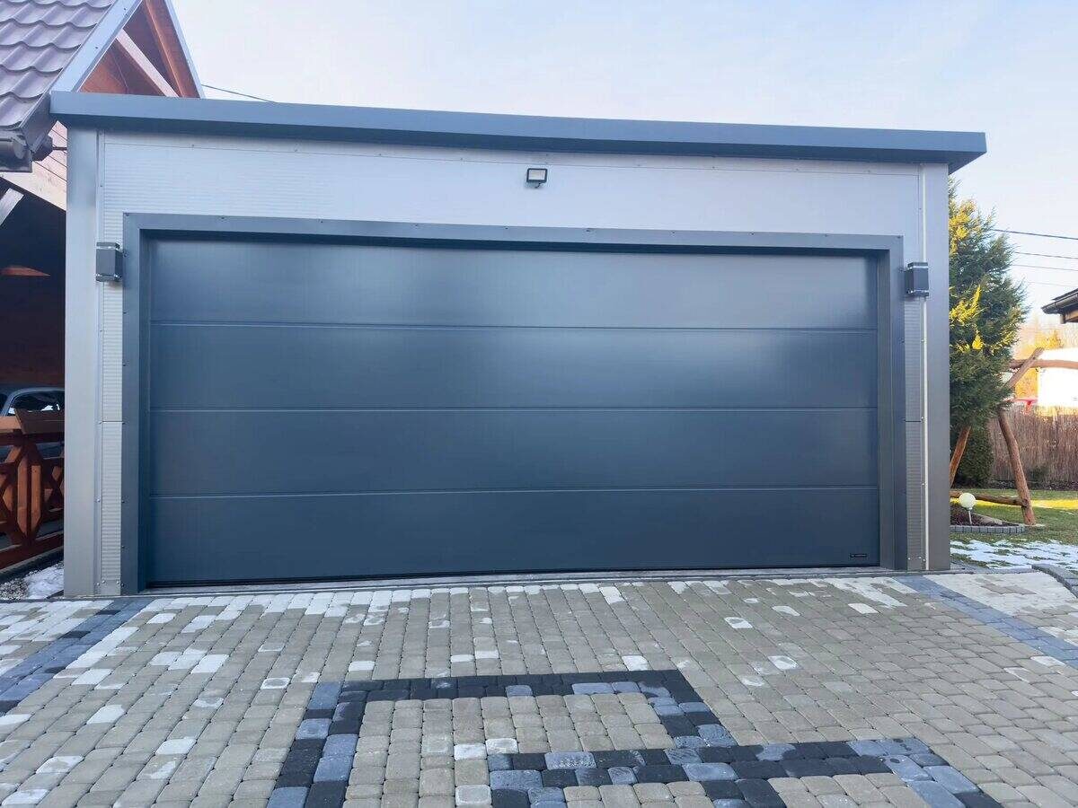 Anthracite insulated PIR garage, front three-quarter view from right on block paving