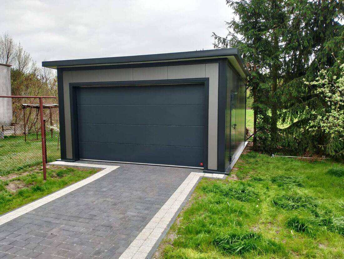 Anthracite insulated PIR garage, straight front view on garden path