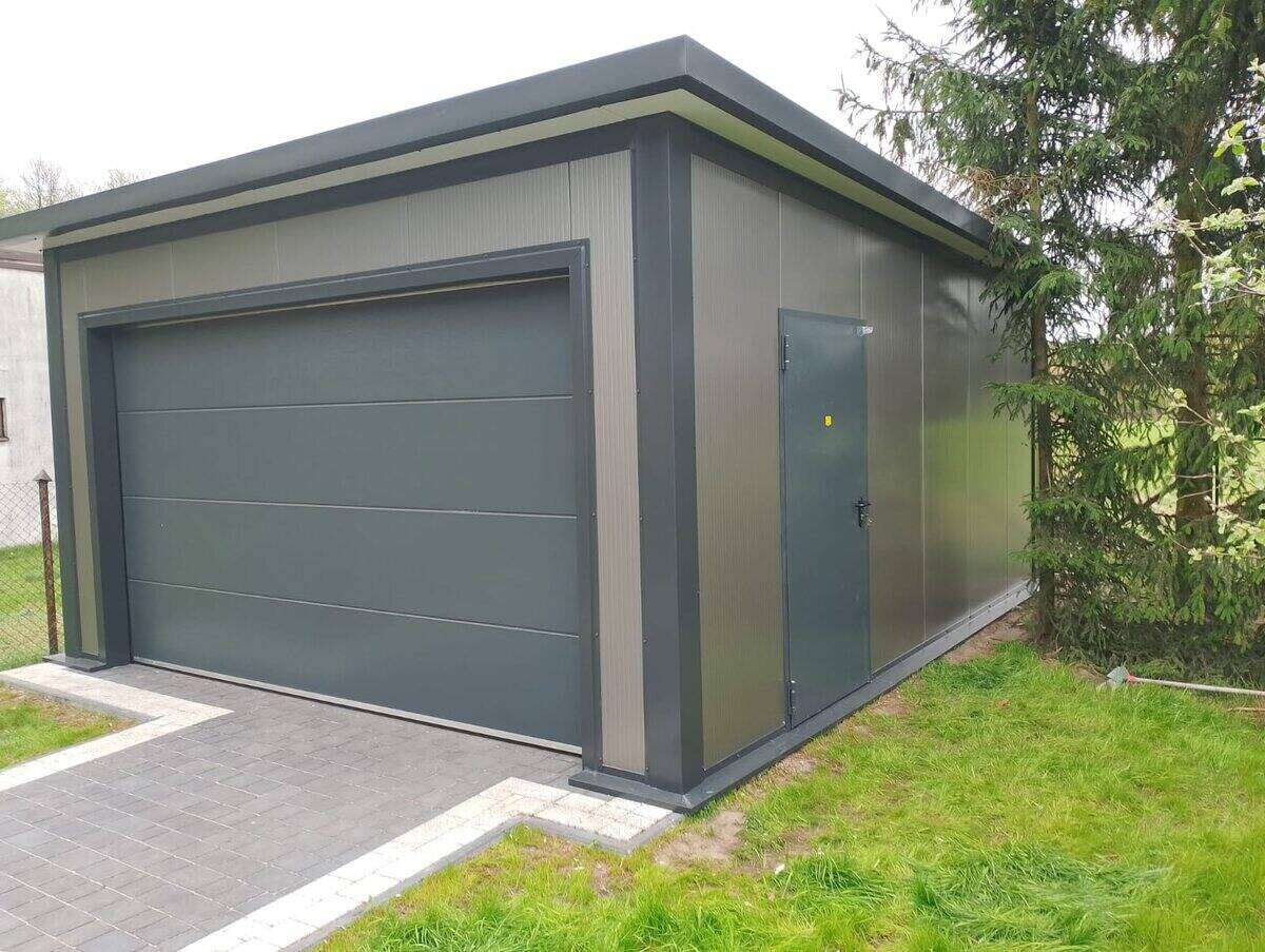 Anthracite insulated PIR garage, front-right three-quarter view on wide driveway