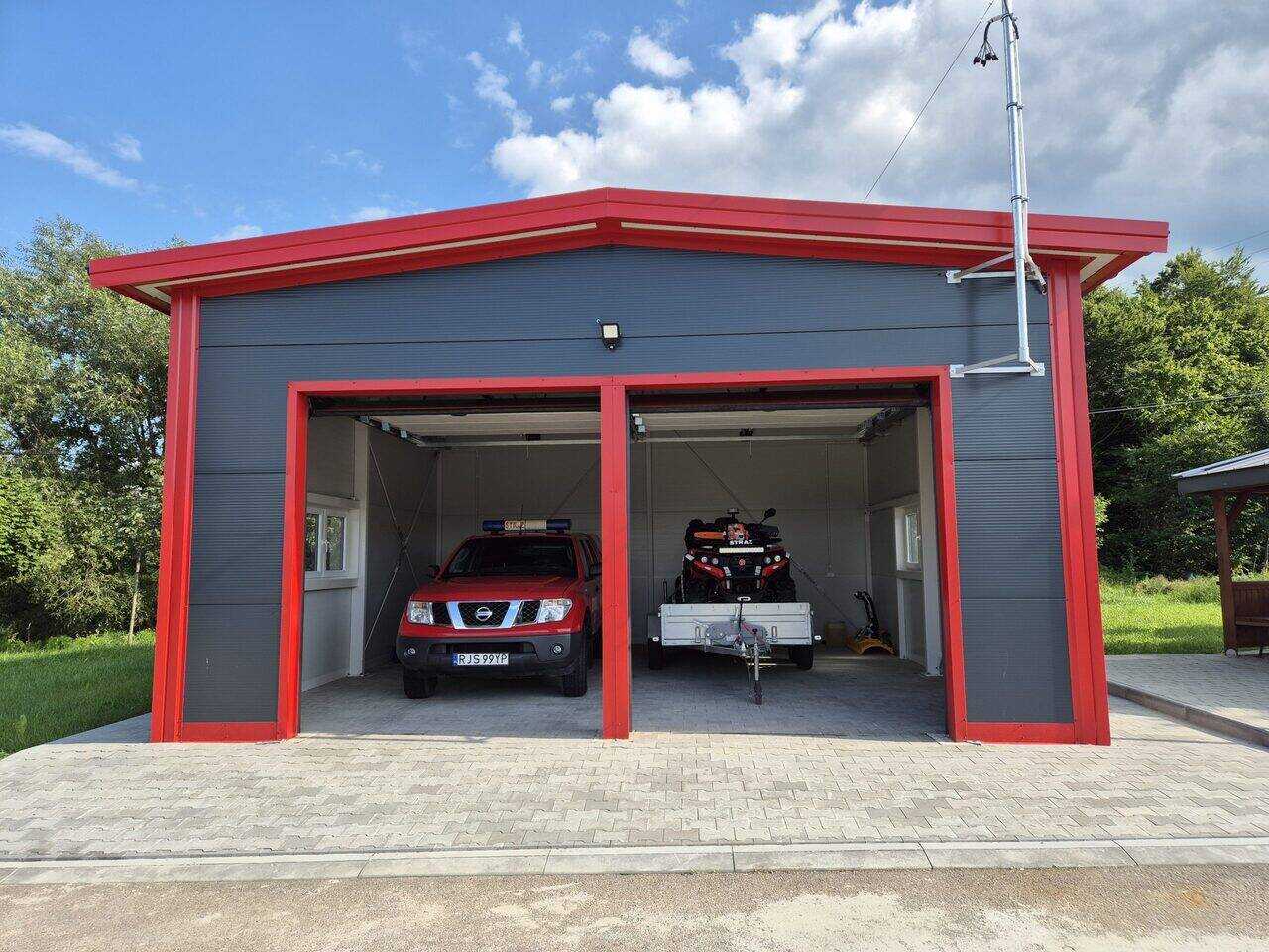 Insulated apex double garage in grey with a contrast red surround, both sectional doors open