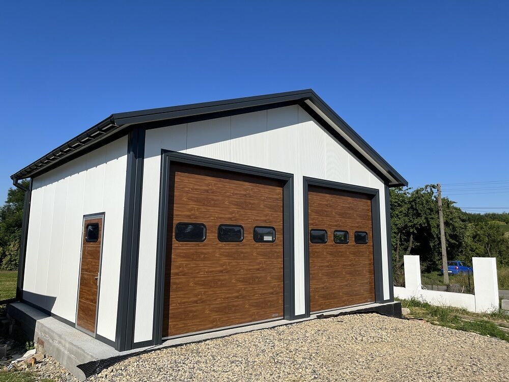 Insulated apex double garage with wood-effect sectional doors, front three-quarter view