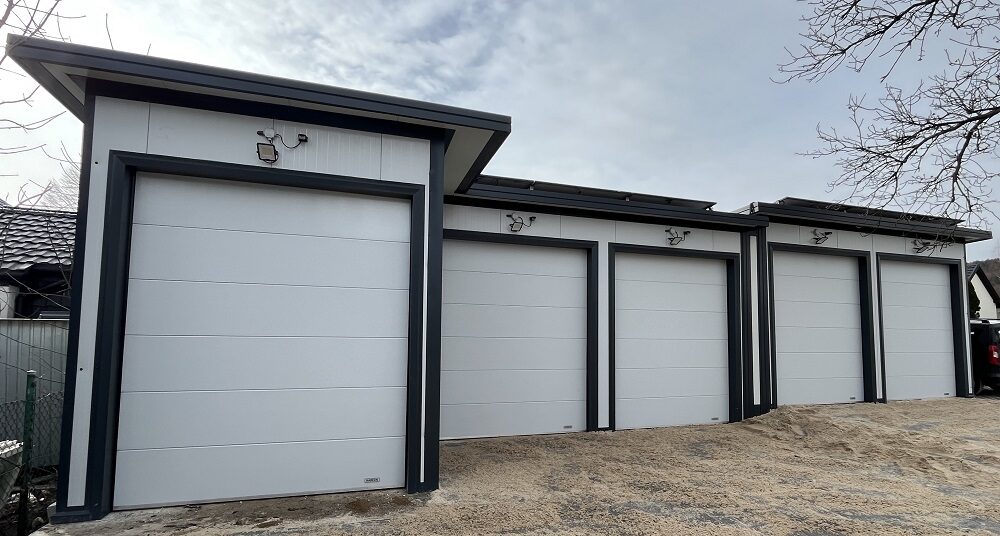 Five-bay insulated garage with anthracite trim, straight-on view, all doors symmetric