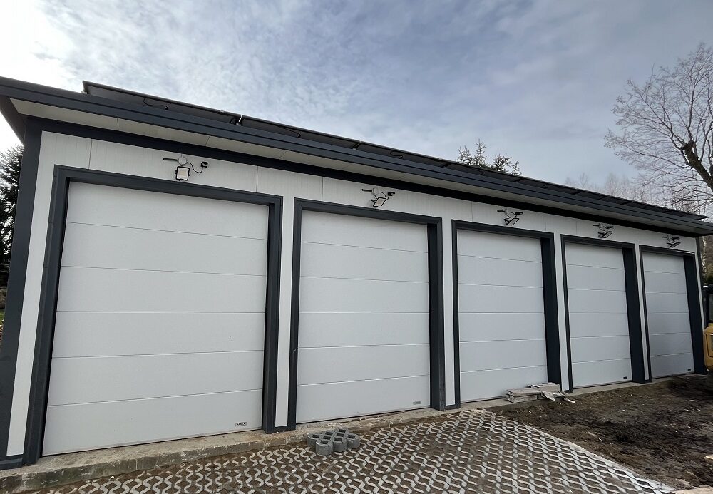 Five-bay insulated garage, opposite three-quarter angle under an atmospheric sky