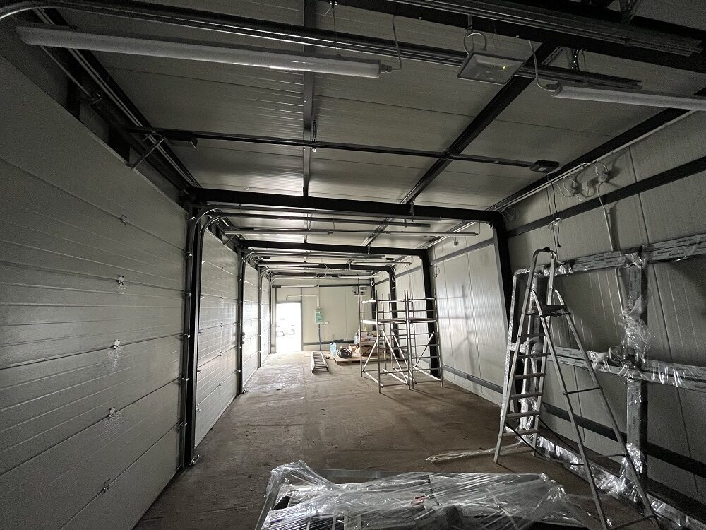 Interior structural view of an insulated garage showing the steel frame and ceiling junction