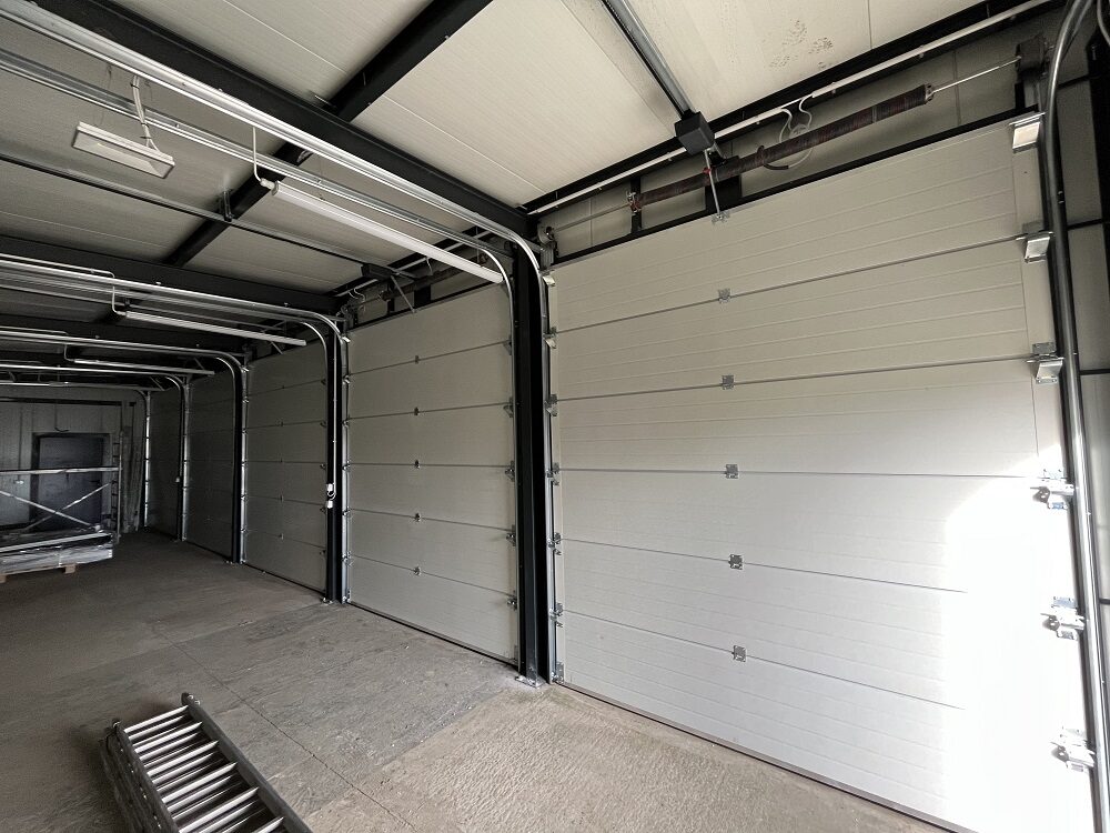 Interior of an insulated garage looking down the bay run towards the doors