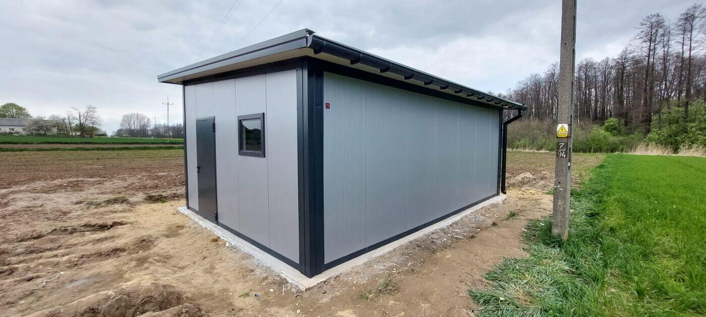 Grey insulated double garage with a side entry door, front three-quarter view