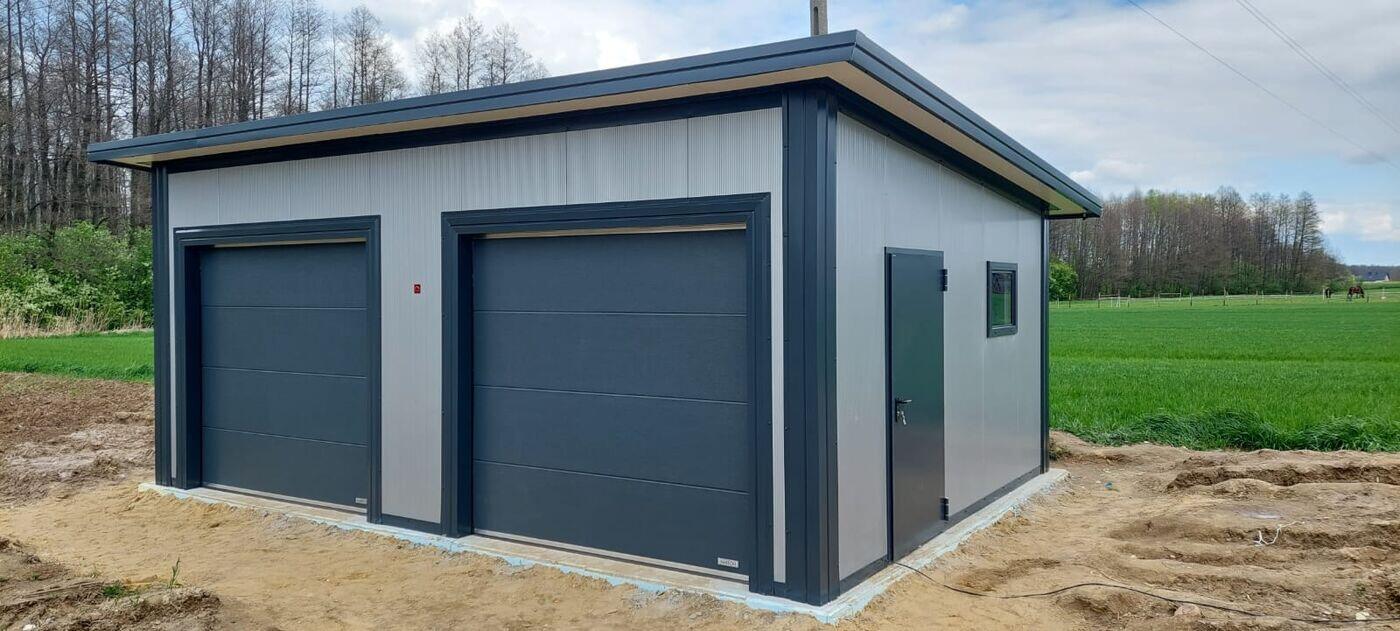 Insulated double garage, front three-quarter view beside greenery
