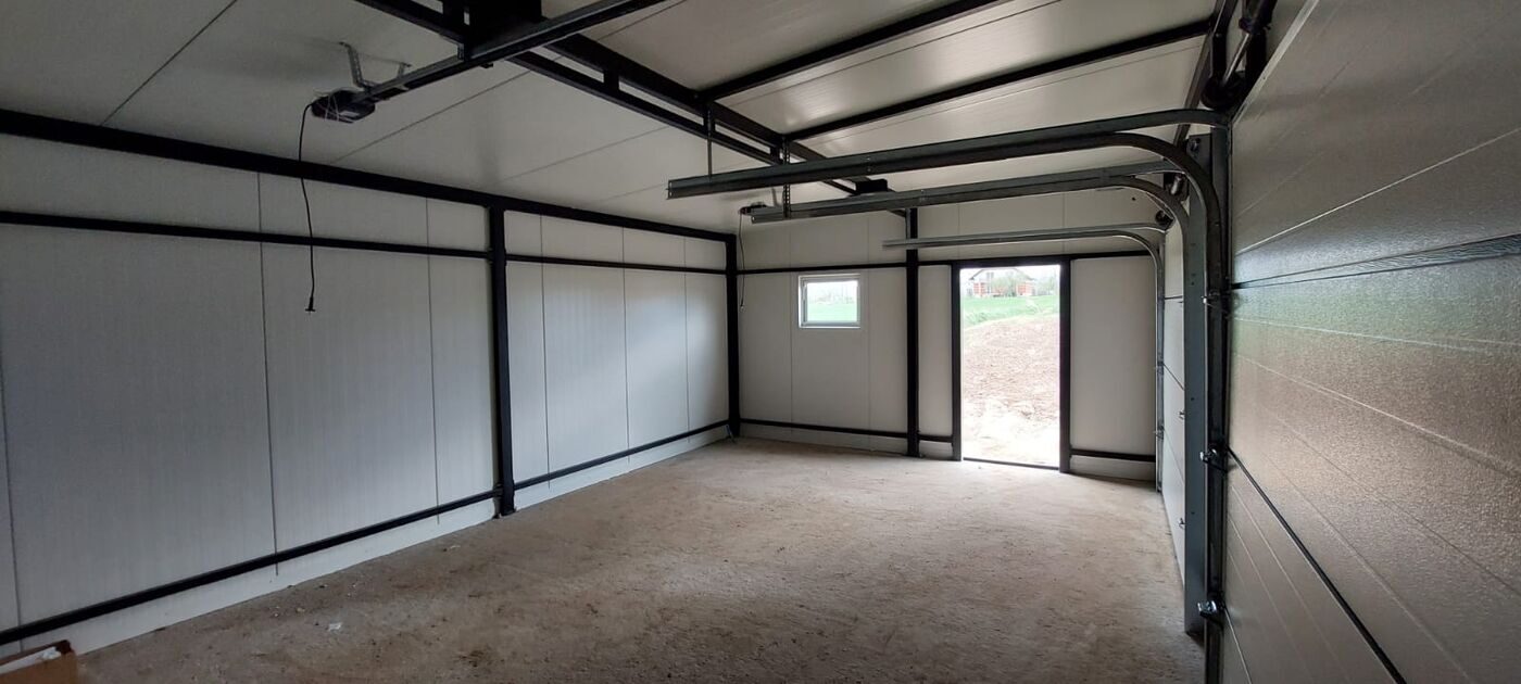 Insulated double garage interior with the sectional door open to the driveway