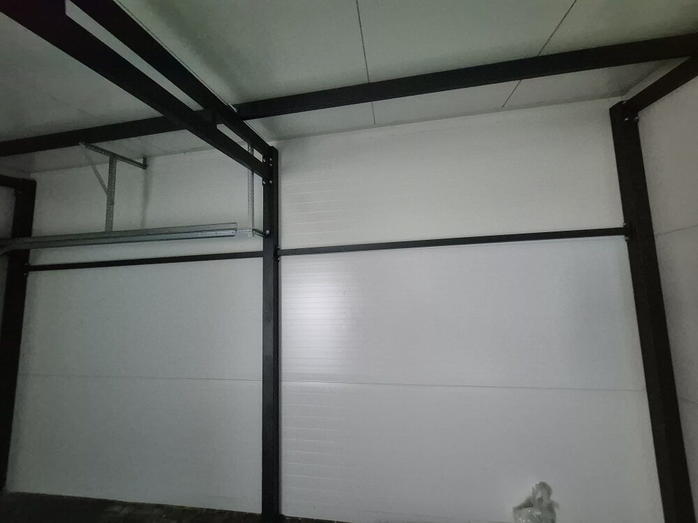 Close-up of an insulated garage wall panel showing the finish texture