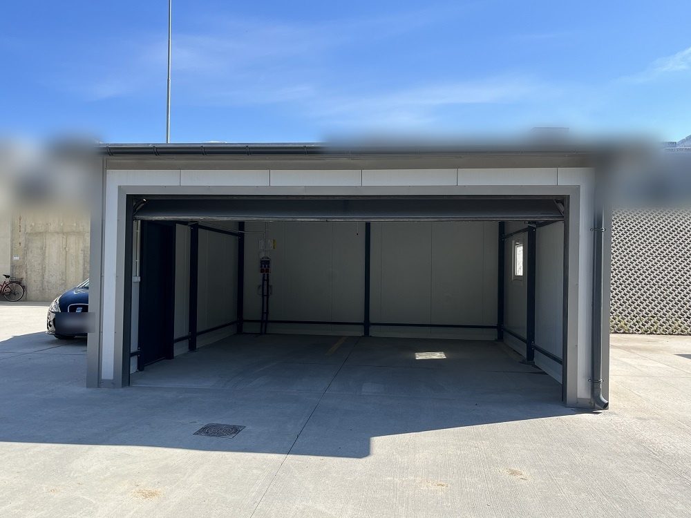 Insulated garage with the sectional door open showing the lined interior and steel frame
