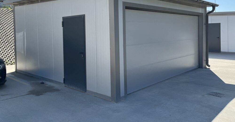 Insulated garage, corner view with a personnel door and the sectional door closed