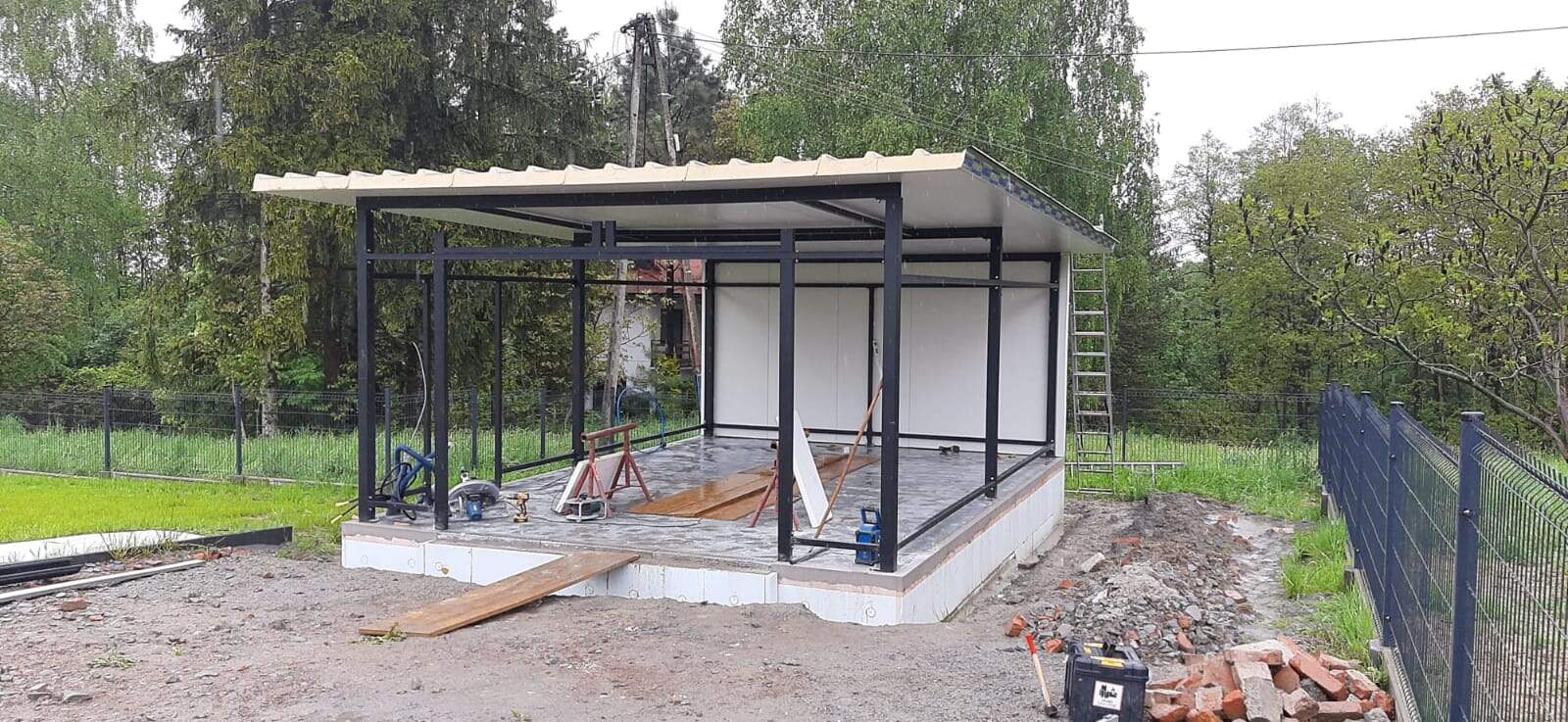 Insulated garage frame from another angle, roof fitted and wall panels partly installed