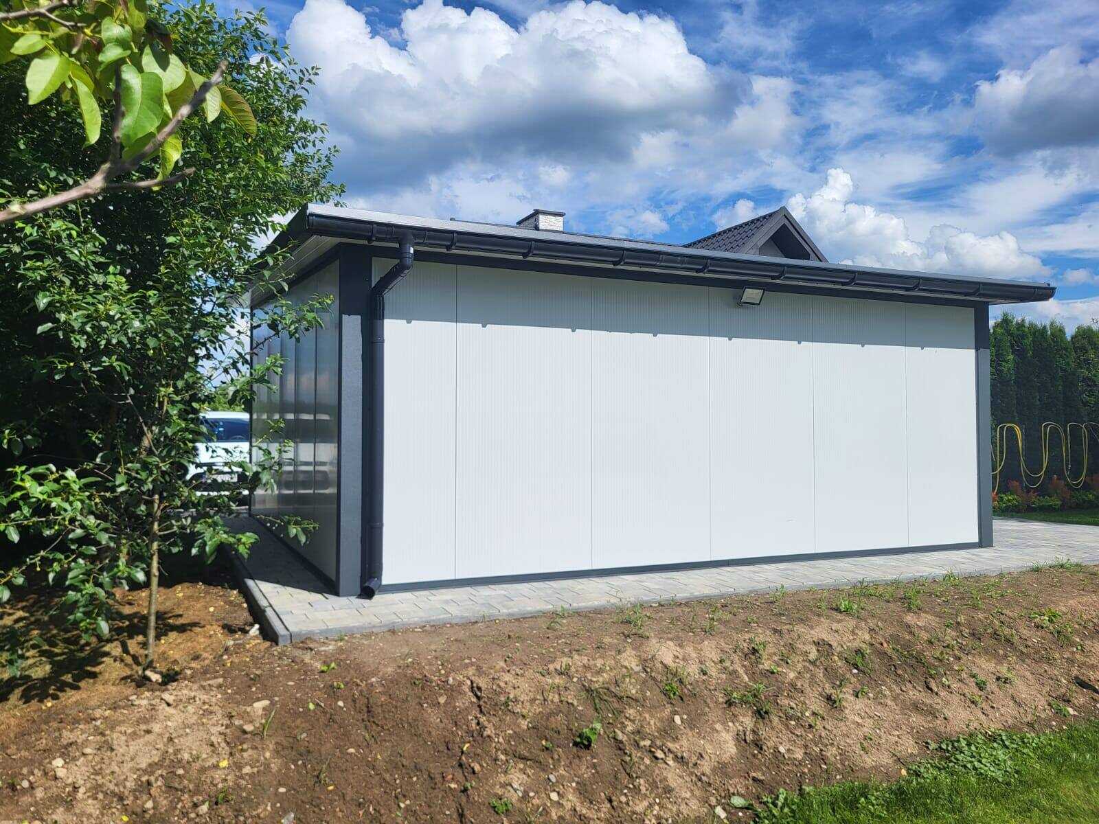 Side view of a white-clad insulated garage with a mono-pitch roof