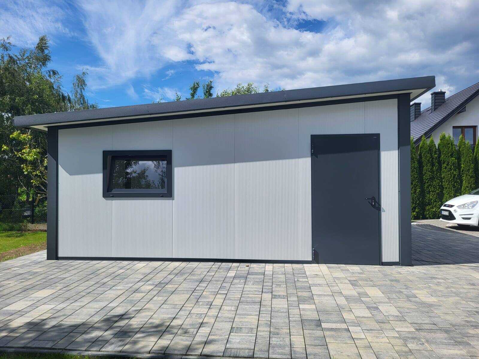 White insulated garage with a side window and an anthracite personnel door, car alongside