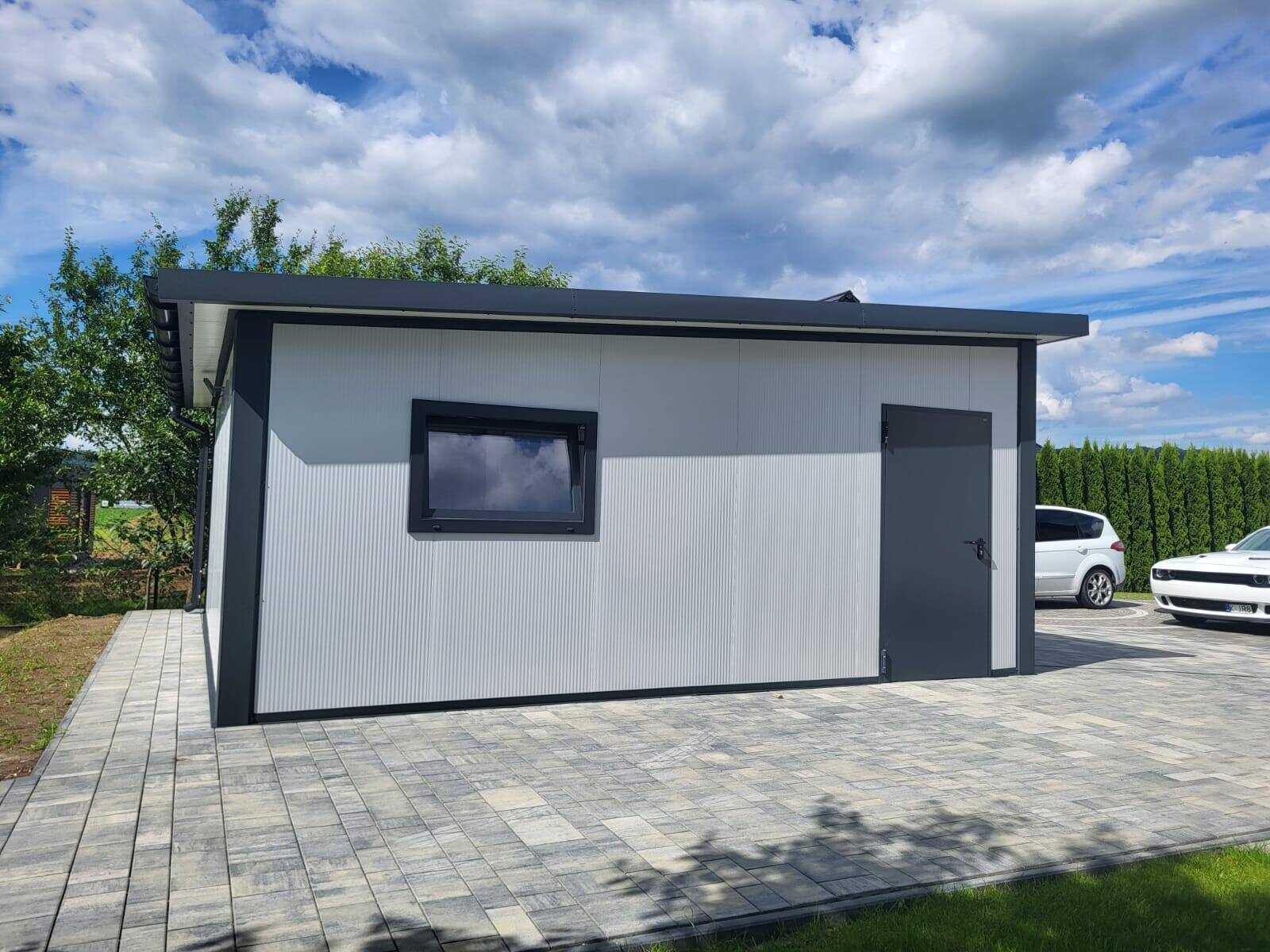 Side elevation of a white insulated garage with a window, car parked alongside