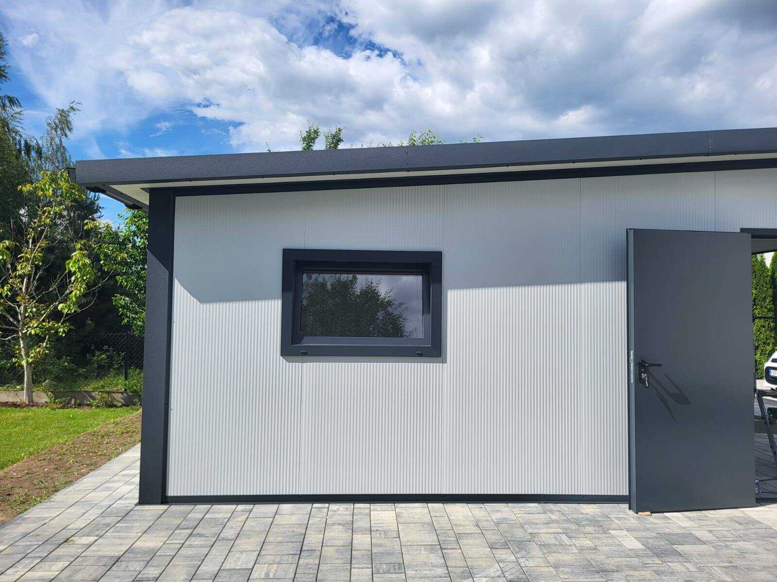 White insulated garage with a side window and entry door beside a neighbouring home