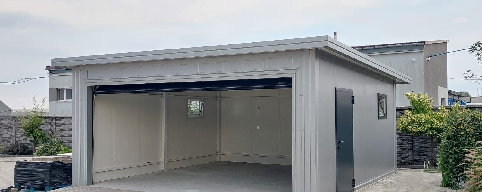 Insulated garage with the sectional door open showing the white-lined interior