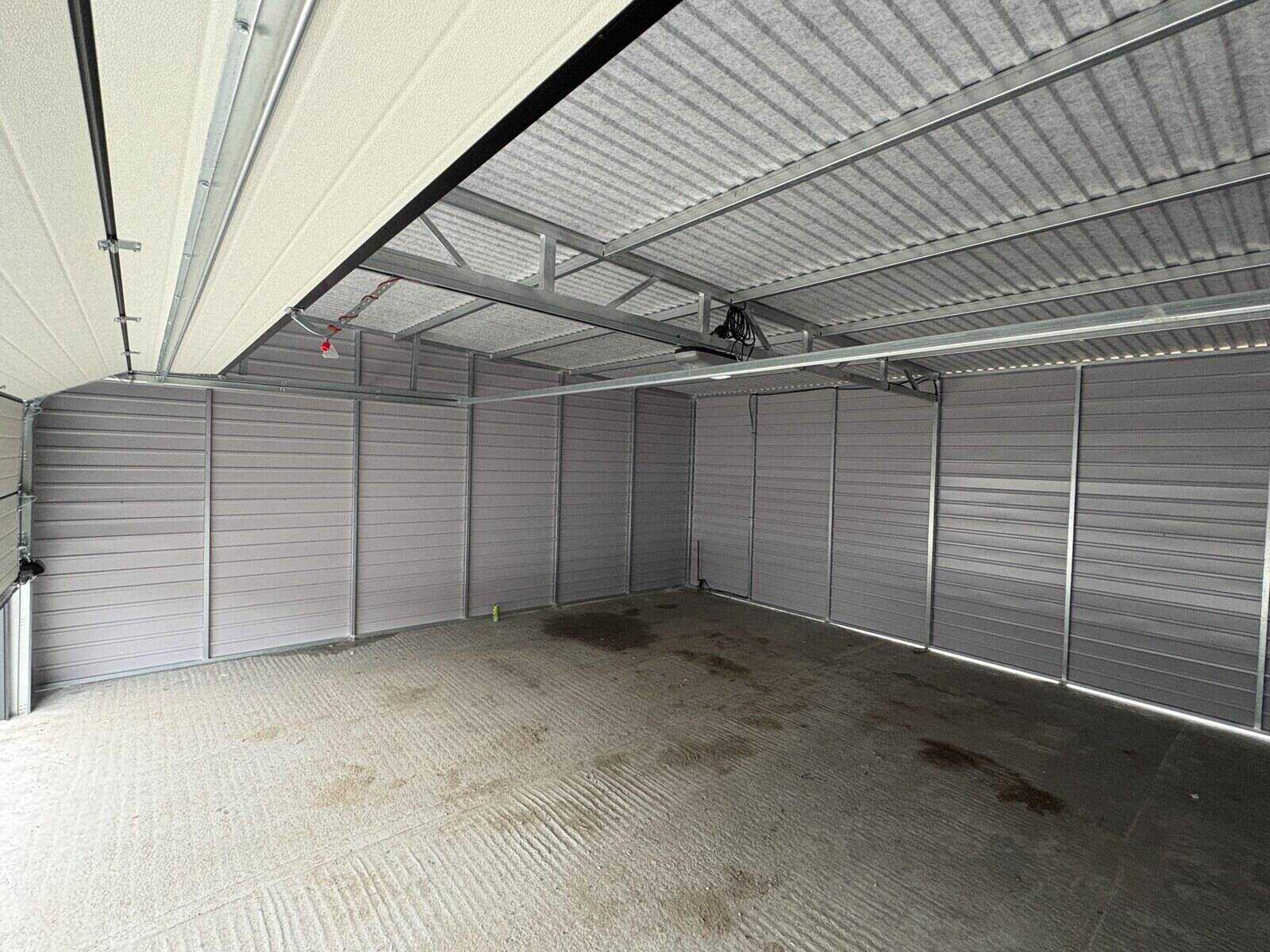 Anthracite steel garage on a prepared base, side elevation