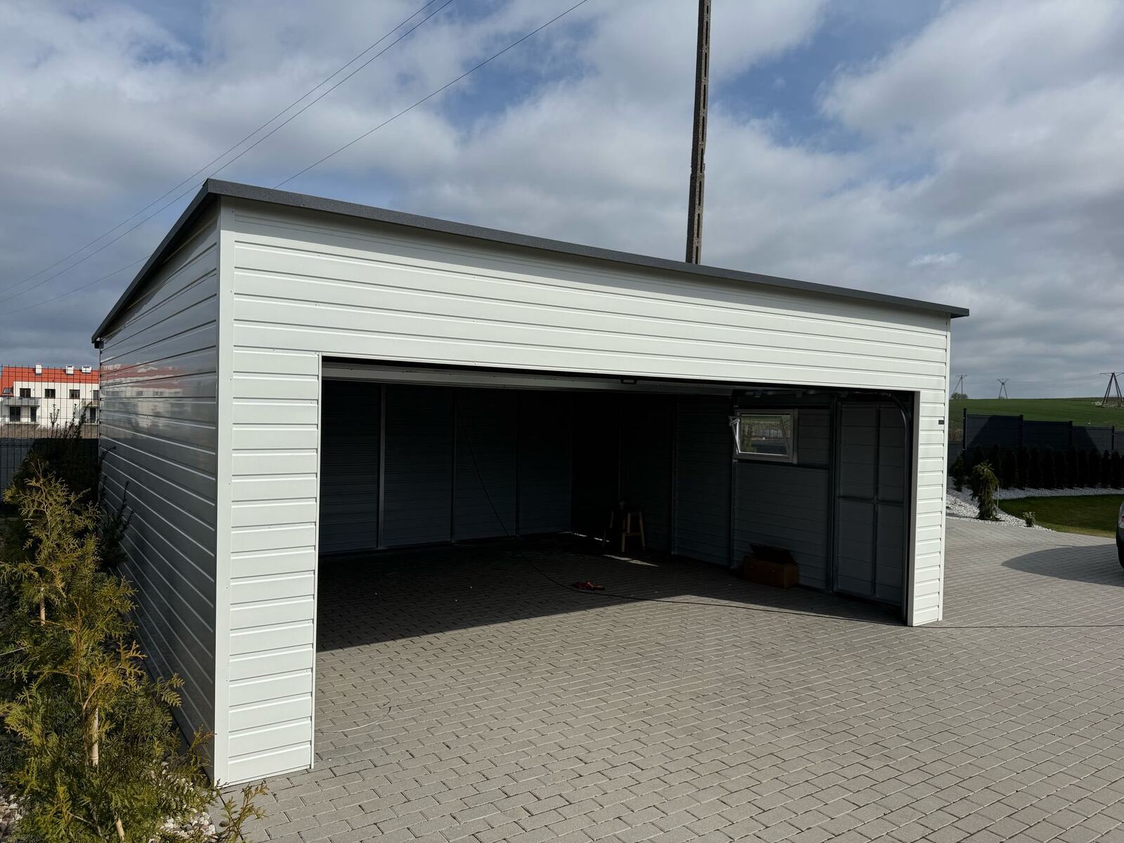 Interior of a white steel garage with the door open