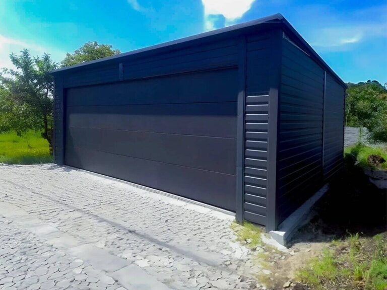 Graphite steel garage with rear-pitch roof in a garden setting with trees